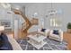 Bright living room with wood floors, staircase, chandelier, and stylish furniture arrangement, perfect for relaxation at 3478 E Park Ave, Gilbert, AZ 85234