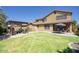 Large backyard with lawn, pergola shaded seating area, and outdoor dining set, perfect for entertaining at 3649 E Hutchins Ct, Gilbert, AZ 85295