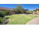 Well-maintained backyard featuring a lush lawn, a pergola with outdoor seating, and mature landscaping at 3649 E Hutchins Ct, Gilbert, AZ 85295