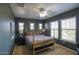 Comfortable bedroom with a brass bed frame, plush bedding, and bright natural light from multiple windows at 3649 E Hutchins Ct, Gilbert, AZ 85295