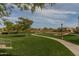 Lush community park featuring green grass, walking paths, and mature trees, creating a serene environment at 3649 E Hutchins Ct, Gilbert, AZ 85295