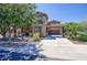 Attractive two-story home featuring a spacious driveway, porte-cochere, and desert-style landscaping at 3649 E Hutchins Ct, Gilbert, AZ 85295
