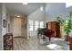 Bright entryway with wood-look tile, tall ceilings and a grand piano at 3649 E Hutchins Ct, Gilbert, AZ 85295