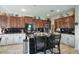 Traditional kitchen featuring dark wood cabinets, central island with counter seating, and modern black backsplash at 3649 E Hutchins Ct, Gilbert, AZ 85295