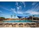 Resort-style swimming pool surrounded by lounge chairs and palm trees, offering a luxurious and relaxing outdoor space at 3649 E Hutchins Ct, Gilbert, AZ 85295