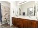 Bathroom featuring a large mirror, wood cabinets, and a double sink at 3810 S Star Canyon Dr, Gilbert, AZ 85297