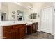 Modern bathroom featuring double sinks, wood cabinets, and a large mirror at 3810 S Star Canyon Dr, Gilbert, AZ 85297