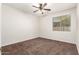 Bright bedroom with a ceiling fan, window, and neutral carpet flooring at 3810 S Star Canyon Dr, Gilbert, AZ 85297