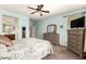 Light-blue bedroom with matching furniture, ceiling fan, and an ensuite bathroom at 3810 S Star Canyon Dr, Gilbert, AZ 85297