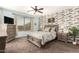 Spacious bedroom featuring a decorative accent wall, large window, and a ceiling fan at 3810 S Star Canyon Dr, Gilbert, AZ 85297