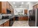 Open kitchen featuring granite counters, tiled backsplash, stainless steel refrigerator, and dark wood cabinets at 3810 S Star Canyon Dr, Gilbert, AZ 85297