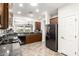 Well-lit kitchen with dark wood cabinetry, granite countertops, and stainless steel refrigerator at 3810 S Star Canyon Dr, Gilbert, AZ 85297
