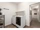 Bright laundry room with white appliances, shelving, and access to hallway with gray walls and recessed lighting at 3810 S Star Canyon Dr, Gilbert, AZ 85297