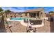 Backyard with sparkling pool, seating area, and desert landscaping with view of brown exterior at 3810 S Star Canyon Dr, Gilbert, AZ 85297