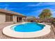 Backyard pool, lounge seating, covered patio, desert landscaping, and privacy fence at 3810 S Star Canyon Dr, Gilbert, AZ 85297