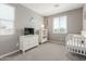 Bedroom bedroom with white furniture, crib, and gray walls with lots of natural light at 3850 E Robert St, Gilbert, AZ 85295