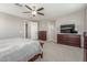 Spacious primary bedroom featuring a ceiling fan, dresser, and carpeted flooring at 3850 E Robert St, Gilbert, AZ 85295
