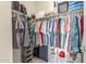 Walk-in closet offers ample storage space with organized hanging clothes and shelves at 3850 E Robert St, Gilbert, AZ 85295