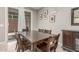 Elegant dining room with a wooden table, matching chairs, and natural light streaming in from the window at 3850 E Robert St, Gilbert, AZ 85295