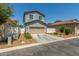 Two-story house showcasing a tan garage door, tidy landscaping, and a spacious private driveway at 3850 E Robert St, Gilbert, AZ 85295