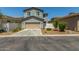 Two-story home featuring a tan garage door, low maintenance landscaping, and a private driveway at 3850 E Robert St, Gilbert, AZ 85295