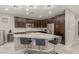 Kitchen features an island with barstool seating, granite countertops, and stainless steel appliances at 3850 E Robert St, Gilbert, AZ 85295