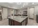 Kitchen island features a dual sink, granite countertop, and dishwasher in a spacious, modern design at 3850 E Robert St, Gilbert, AZ 85295
