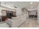 Spacious living room showcasing a large TV, ceiling fan, staircase, and access to the dining area at 3850 E Robert St, Gilbert, AZ 85295