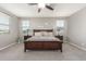Main bedroom with a ceiling fan, neutral decor, and plenty of natural light from the surrounding windows at 3850 E Robert St, Gilbert, AZ 85295