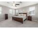 Main bedroom featuring a ceiling fan, carpeted floor, and plenty of natural light from the windows at 3850 E Robert St, Gilbert, AZ 85295