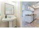 Bathroom sink and mirror. View into the kitchen with stainless appliances and tile floors at 3930 W Monterey St # 136, Chandler, AZ 85226