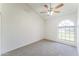 Bright bedroom featuring neutral carpet, ceiling fan, and large arched window at 3930 W Monterey St # 136, Chandler, AZ 85226