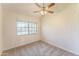 Bright bedroom featuring neutral carpet, ceiling fan, and a window at 3930 W Monterey St # 136, Chandler, AZ 85226