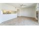 Spacious living room with open access to the kitchen, neutral walls, and a modern ceiling fan at 3930 W Monterey St # 136, Chandler, AZ 85226