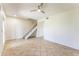Bright living room featuring neutral walls, tiled floors, a modern ceiling fan, and a staircase at 3930 W Monterey St # 136, Chandler, AZ 85226