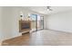 Bright living room featuring neutral tile flooring, a fireplace, and a sliding glass door at 3930 W Monterey St # 136, Chandler, AZ 85226