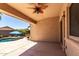Covered back patio featuring ceiling fan and view of pool and desert landscaping at 3935 E Graphite Rd, San Tan Valley, AZ 85143
