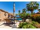 Picturesque backyard featuring a sparkling pool, desert landscaping and an outdoor dining area at 3935 E Graphite Rd, San Tan Valley, AZ 85143