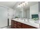 Bathroom showcasing double sinks, wood cabinets, framed mirror and glass enclosed shower at 3935 E Graphite Rd, San Tan Valley, AZ 85143