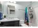 Bright bathroom with modern vanity, square mirror and combination tub and shower with sea life curtain at 3935 E Graphite Rd, San Tan Valley, AZ 85143