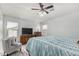 Inviting bedroom with neutral colors, wood-look floors, and a dresser with television at 3935 E Graphite Rd, San Tan Valley, AZ 85143