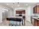 Bright kitchen featuring a blue island with granite counters, cherry wood cabinets, and a convenient microwave and cooktop at 3935 E Graphite Rd, San Tan Valley, AZ 85143