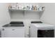 Convenient laundry area with white front load washer and dryer and storage shelf at 3935 E Graphite Rd, San Tan Valley, AZ 85143
