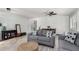 Inviting living room with light walls, gray sofas, a woven ottoman, stylish decor, and open access to the dining area at 3935 E Graphite Rd, San Tan Valley, AZ 85143