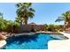 Sparkling pool surrounded by tropical landscaping and rock features at 3935 E Graphite Rd, San Tan Valley, AZ 85143