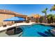 Beautiful pool area featuring mature desert landscaping, BBQ and outdoor dining spaces at 3935 E Graphite Rd, San Tan Valley, AZ 85143