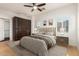 Cozy bedroom showcasing a bed, ceiling fan, wood floors, and wardrobe cabinet at 3935 E Rough Rider Rd # 1183, Phoenix, AZ 85050