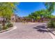 Welcoming community entrance featuring lush landscaping, a decorative sign, and a paved road, creating an inviting atmosphere at 3935 E Rough Rider Rd # 1183, Phoenix, AZ 85050