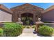Elegant community entrance with a stone archway, iron gate, and lush landscaping creating a welcoming ambiance at 3935 E Rough Rider Rd # 1183, Phoenix, AZ 85050