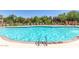 Community pool with ample seating surrounded by mature landscaping at 3935 E Rough Rider Rd # 1183, Phoenix, AZ 85050
